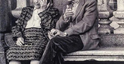 Schwarz-Weiß Fotografie von einem Paar im Alter auf einer Parkbank