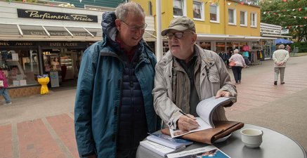 Senior zeigt sein Fotobuch über Basstölpel auf Helgoland